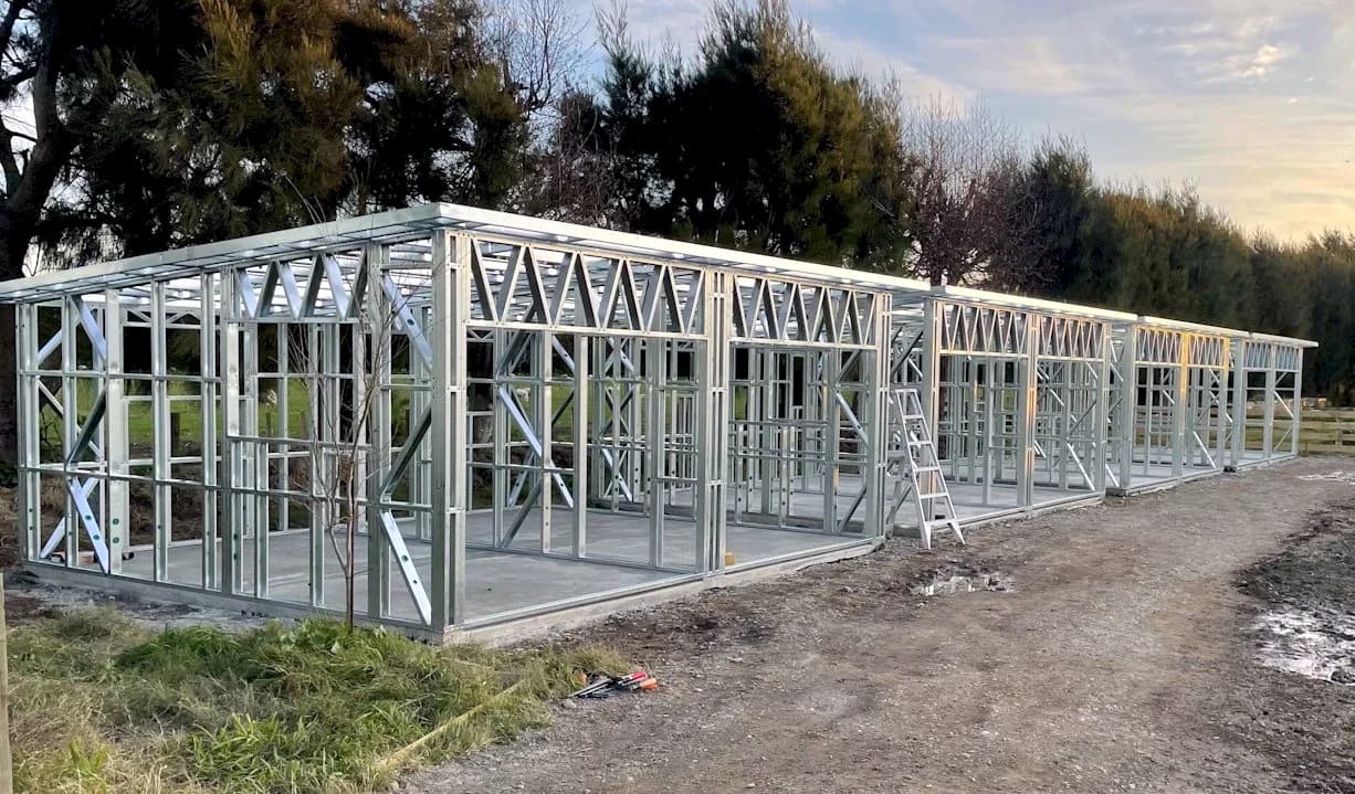 A long run of light gauge steel wall and roof framing on site, before cladding